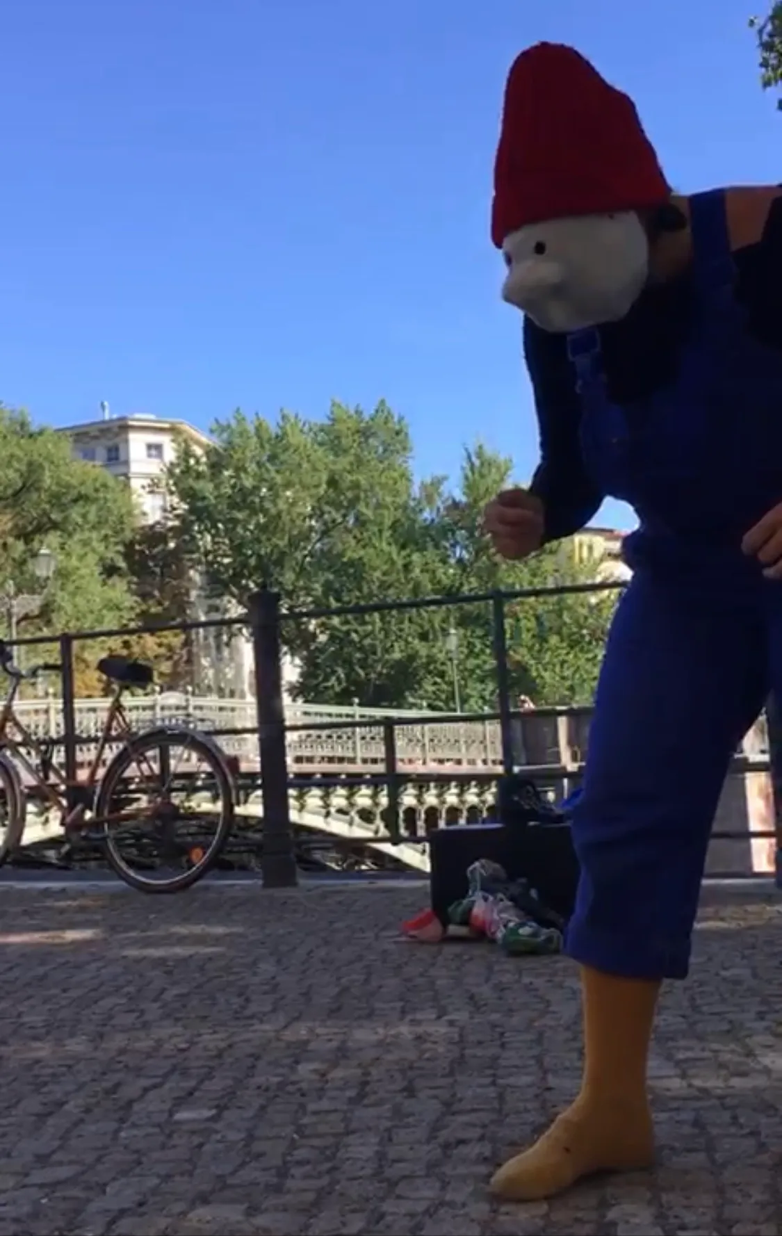 Ruthie in red nose mask outdoor performance