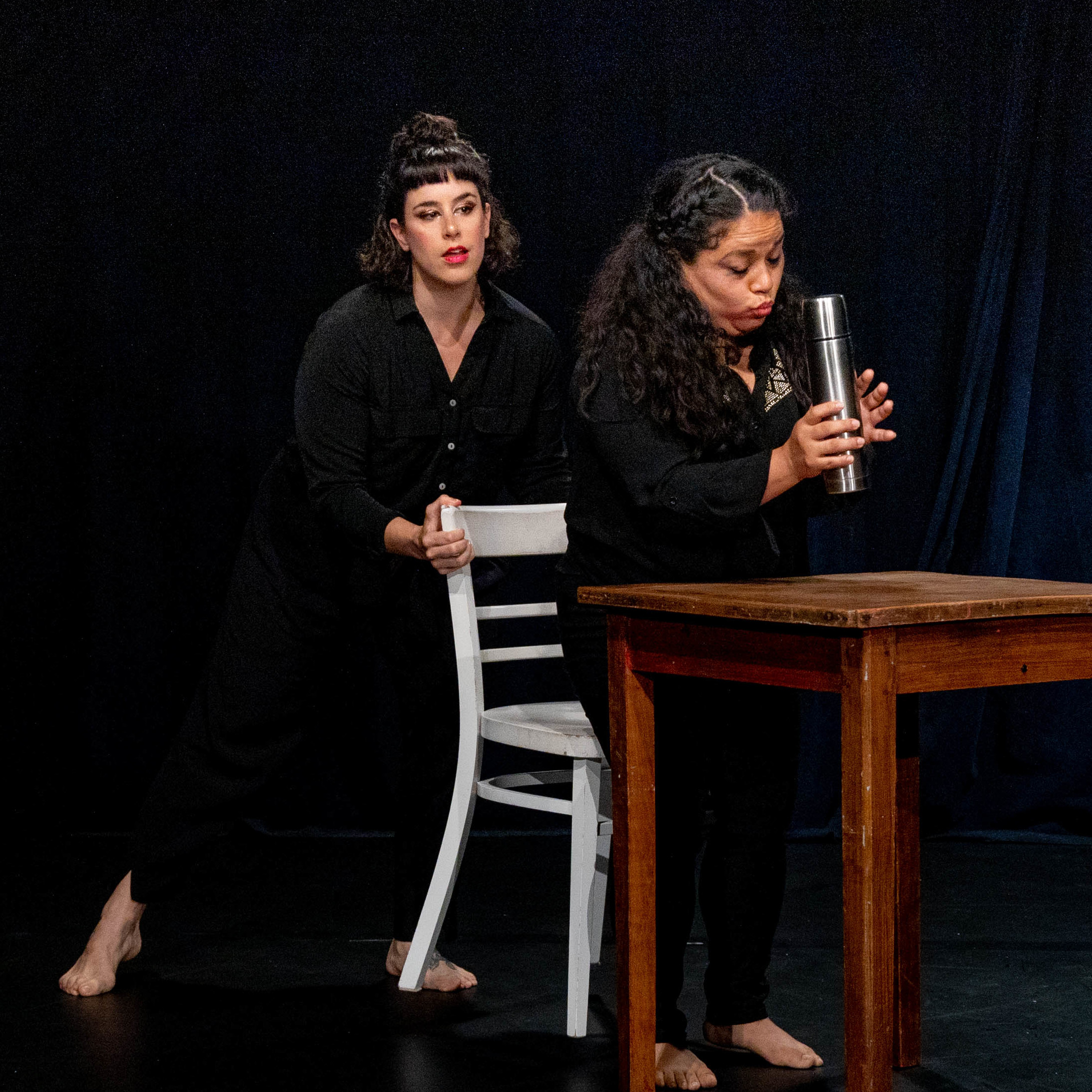 Two performers in a corporeal mime scene